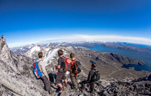 four-friends-hiking-to-the-top-of-kingittorsuaq-mountain-outside-of-nuuk-and-taking-in-the-view-southward-toward-ameralik-fjord.jpg